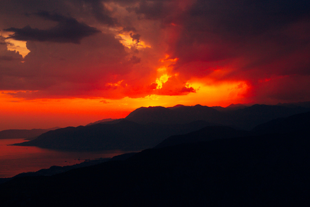 Sunset in Montenegro over the mountains and the sea. Orange sunsets.の写真素材