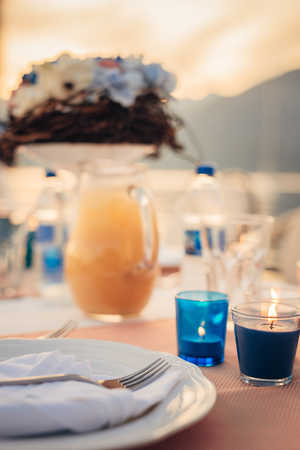 Table setting at a wedding banquet. Decoration flowers. A close-up of a plate with cutlery.の写真素材