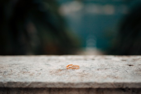 Wedding rings on the stones in the grass. Wedding in Montenegro.の写真素材