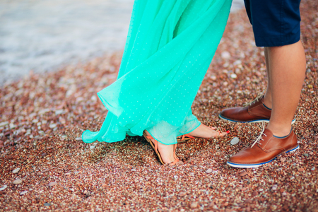 Womens and mens feet in the sand. Wedding in Montenegroの写真素材
