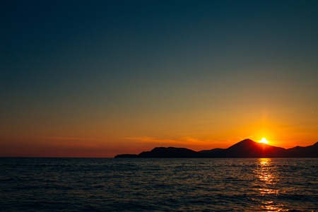 Sunset in Montenegro over the mountains and the sea. Orange sunsets.の写真素材