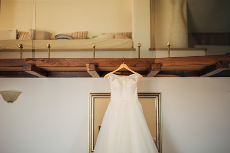 The brides dress on a hanger in the room in Montenegroの写真素材