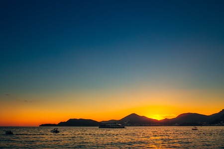 Sunset in Montenegro over the mountains and the sea. Orange sunsets.の写真素材