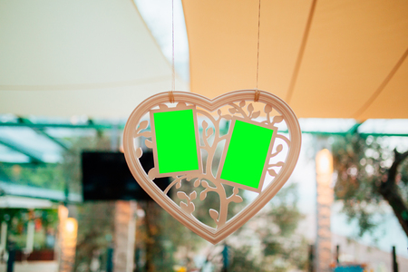 White frame for several photos. Green backgroundの写真素材