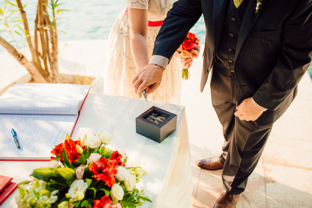 Wedding rings of the newlyweds. Engagement gold rings. Wedding in Montenegro.の写真素材