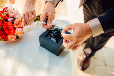 Wedding rings of the newlyweds. Engagement gold rings. Wedding in Montenegro.の写真素材