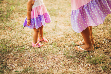 Childrens legs and feet of parents. The family walks along the beach in Montenegro.の写真素材