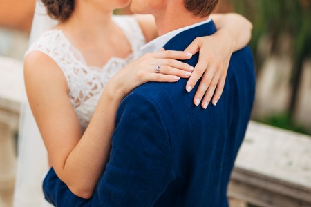 Bride and groom at wedding Day walking Outdoors on spring nature. Bridal couple, Happy Newlywed woman and man embracing in green park. Loving wedding couple outdoor. Bride and groomの写真素材