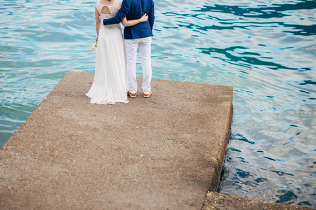 Female and male feet on the dock. Wedding in Montenegroの写真素材