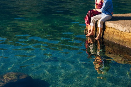 Female and male feet on the dock. Wedding in Montenegroの写真素材