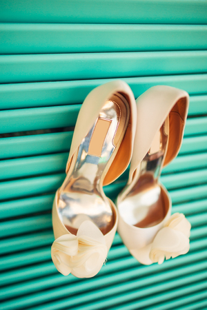 Wedding shoes of the bride on a blue wooden background. Wedding in Montenegro.の写真素材