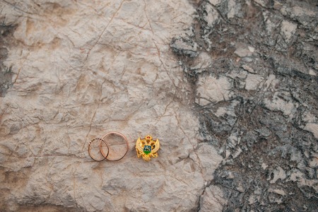 Wedding rings on the stones in the grass. Wedding in Montenegro.の写真素材