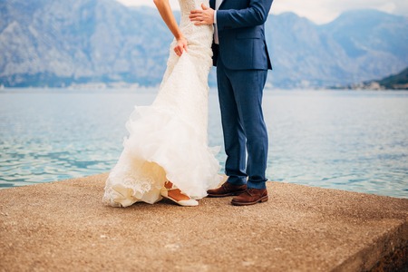 Female and male feet on the dock. Wedding in Montenegroの写真素材