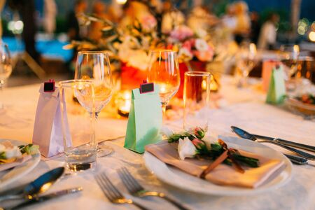 Table setting at a wedding banquet. Decoration flowers. A close-up of a plate with cutlery.の写真素材