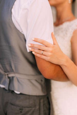 Bride and groom at wedding Day walking Outdoors on spring nature. Bridal couple, Happy Newlywed woman and man embracing in green park. Loving wedding couple outdoor. Bride and groomの写真素材
