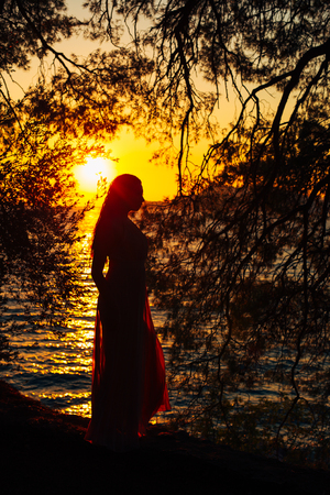 Silhouettes at sunset on the beach in Montenegroの写真素材