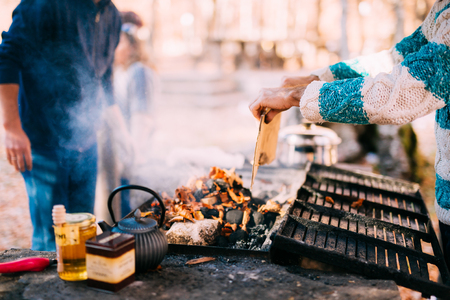 The guy fries a shish kebab on an open fire on a brazier.の写真素材