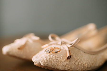 Cream shoes of the bride on green on a wooden table table. Wedding in Montenegro.の写真素材