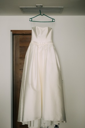 The brides dress on a hanger in the room in Montenegroの写真素材