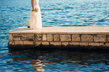 Female and male feet on the dock. Wedding in Montenegroの写真素材