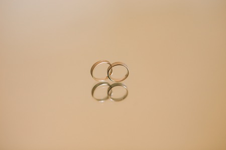 Wedding rings of the newlyweds on the mirror. Engagement gold rings. Wedding in Montenegro.の写真素材