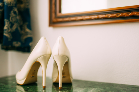 Cream shoes of the bride on a green marble table. Wedding in Montenegro.の写真素材