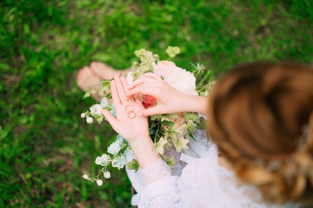 Wedding rings in a wooden box for rings in the hands of the bride. Wedding jewelry.の写真素材