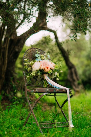Wedding bouquet of peonies on a vintage metal chair Wedding in Montenegro.の写真素材