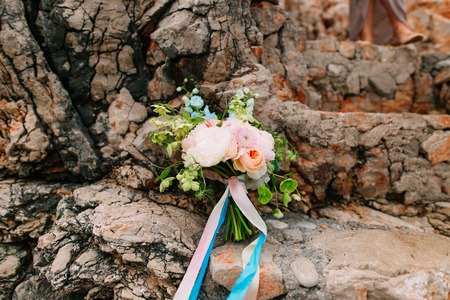 Wedding bouquet of peonies on the rocks by the sea. Wedding in Montenegro.の写真素材