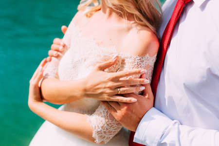 The groom embraces the bride on the beach. Wedding in Montenegro and Croatia.の写真素材