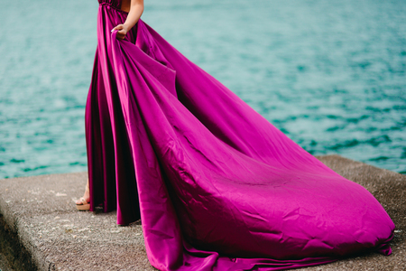 Touches the dress. The bride waving her dress. Fluttering dress of the bride. Wedding in Montenegro.の写真素材