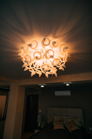 Chandelier in the apartment. A beautiful chandelier on the ceiling of the apartment.の写真素材