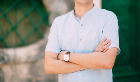 Mens hands with a watch. Hands of the groom. Wedding at the sea in Montenegro.の写真素材