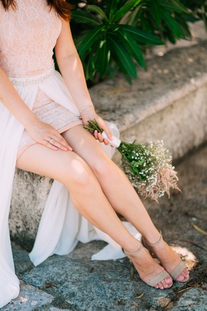 Legs of the bride and bouquet. Wedding in Montenegroの写真素材