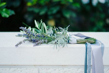 Wedding bouquet of lavender with ribbon on a stone backgroundの写真素材