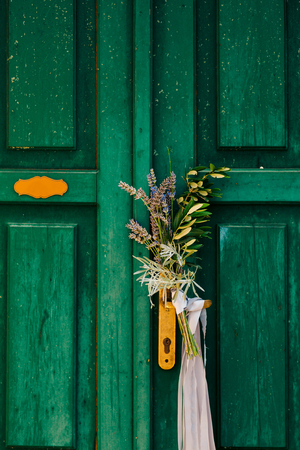 Wedding bridal bouquet of lavender on an old wooden door. Wedding in Montenegro, Adriatic.の写真素材