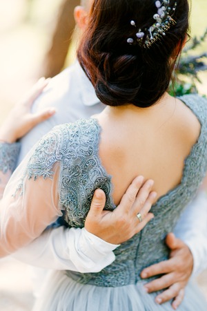 The groom embraces the bride in the forest. Wedding in Montenegro and Croatia.の写真素材