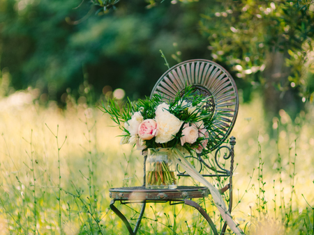 Wedding bouquet of peonies on a vintage metal chair Wedding in Montenegro.の写真素材
