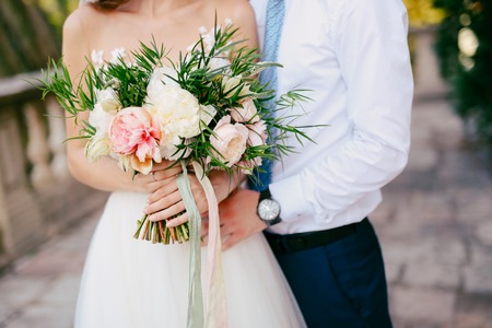 Wedding bouquet of peonies in the hands of the bride. Wedding in Montenegro.の写真素材