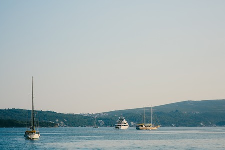 Moored boats in the Bay of Kotor, on the background of the peninsula Lustica in Montenegro. Away from the coastの写真素材