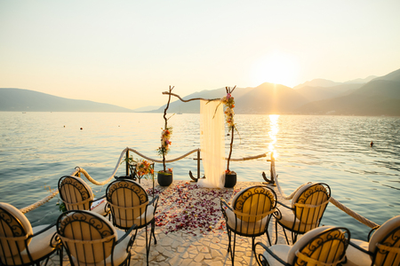 Wooden arch for the wedding ceremony at sunset. On the shore of the Bay of Kotor, Tivat, Montenegroの写真素材