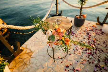 Table for the wedding ceremony, flower arrangement. Wedding decorations. Wedding at the sea in...