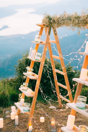 Wedding in Montenegro. Wedding Arch on Mount Lovcen, Montenegro. Kotor Bay View. Wooden arch with candlesの写真素材