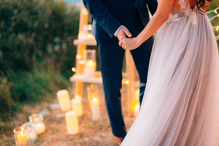 The newlyweds hold hands at the wedding ceremony. Couple holding hands. Wedding in Montenegro.の写真素材