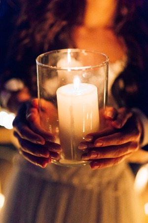 A candle in the hands of a newlywed couple. Wedding in Montenegro.の写真素材