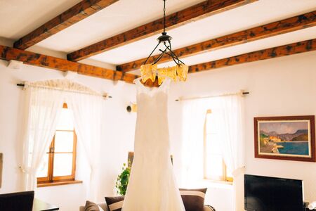 Wedding Dress The bride is hanging on a chandelier.の写真素材