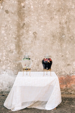 Lemonade in a glass barrel. Flasks for spilling drinks. Lemonade glass jars at the wedding reception. An adorable summer lemonade stand.の写真素材