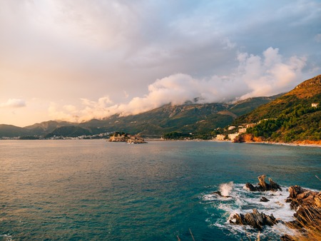 Island of Sveti Stefan, view from the beach of Crvena Glavica, at sunset. Montenegro, the Adriatic Sea, the Balkans.の写真素材