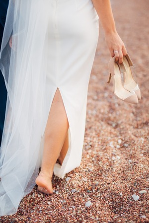 Womens and mens feet in the sand. Wedding in Montenegroの写真素材
