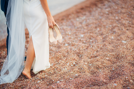 Womens and mens feet in the sand. Wedding in Montenegroの写真素材